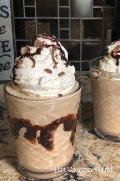 two glasses filled with ice cream and whipped cream