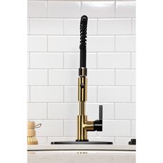 a kitchen faucet with black and gold fixtures