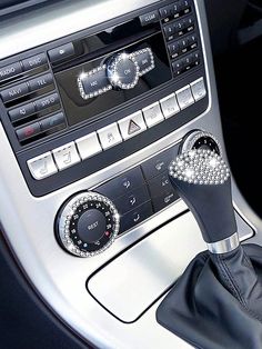 the interior of a car with an automatic gear lever and knobs on it's center console