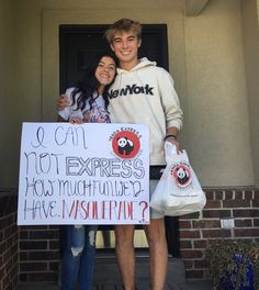 two people standing in front of a building holding bags and a sign that says, i can't not express how much they have mishappine?