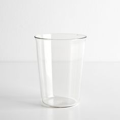 a clear glass cup sitting on top of a white table