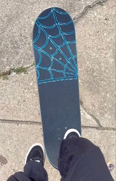 a person standing next to a blue skateboard