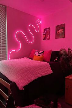 a bedroom with pink walls and neon lights on the wall, along with a bed