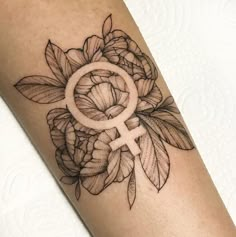 a woman's arm with a tattoo on it and a flower in the center