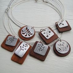 a necklace with five different designs on it