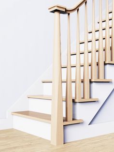 a wooden stair case next to a white wall