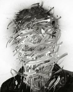 a black and white photo of a man's head covered in shredded up papers