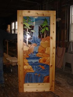 a man standing in front of a wooden door with a painting on it's side