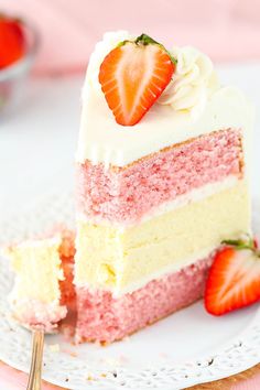 a slice of strawberry cake on a plate with strawberries