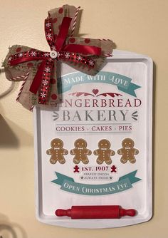 gingerbread bakery cookie cookies and pies sign hanging on the wall with red ribbon