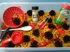 a plastic container filled with pasta and cooking utensils