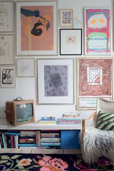 a living room filled with lots of pictures on the wall