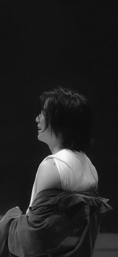 a black and white photo of a woman sitting down