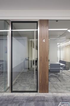 an office with glass walls and sliding doors