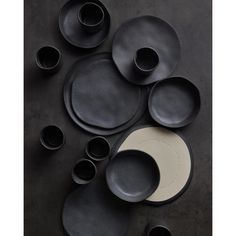 black and white dishes are arranged on a table