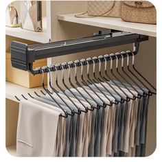 an organized closet with clothes hanging on hangers