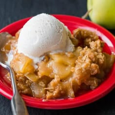 a red plate topped with apple crisp and ice cream