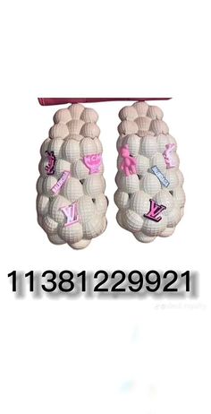 two baby shoes with pink bows and letters on them are shown in front of a white background