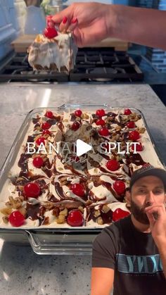 the man is making a dessert with cherries and whipped cream on his face in front of an uncooked dish