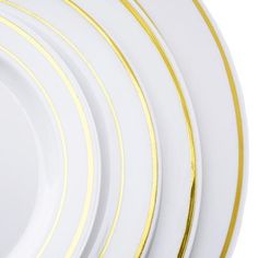 four white and gold plates stacked on top of each other