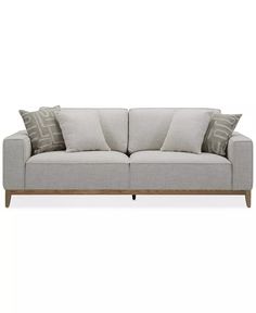 a gray couch with pillows on top of it