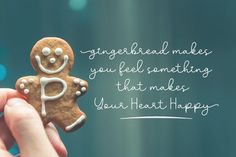 a person holding a gingerbread cookie with the words, gingerbread make you feel something that makes your heart happy