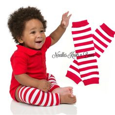 a baby sitting on the floor with three pairs of red and white striped leggings