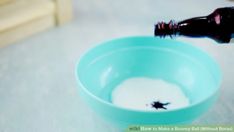 a bottle is pouring milk into a blue bowl