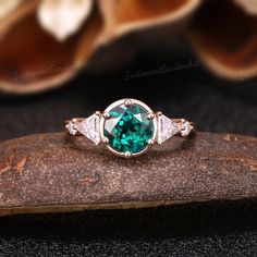 Vintage Emerald Engagement Ring Art Deco Green Gemstone Promise Ring Triangle Moissanite Wedding Ring Rose Gold Ring Anniversary Gift for Women RING DESCRIPTION ✦Engagement Ring ✴Center Stone -Lab Emerald Shape - Round Cut Size - 7mm ✴Side Stones - Moissanite Shape - Round Cut Weight - About 0.43ct ✴Band Width - About 1.8mm ✴Ring Metal: Available in rose gold plated, yellow gold plated, 925 sterling silver, 10k or 14k solid rose, yellow or white gold. MAKING & SHIPPING ✦PAYMENT PLAN ♡ We provide Antique Emerald Ring Unique, Vintage Emerald Engagement Rings, Engagement Rings Art Deco, Emerald Wedding Rings Set, Emerald Engagement Rings, Antique Emerald Ring, Wedding Ring Rose Gold, Vintage Emerald Engagement Ring, Rings Art Deco