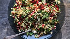 a salad with pomegranate and other vegetables on a plate