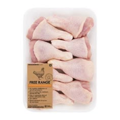 raw chicken pieces in a plastic container with the label free range on it's side