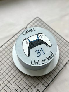 a cake with a video game controller design on it's side and the words level 31 unlocked