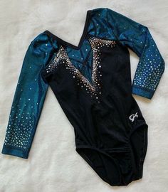 a gymnastics leotard is laying on the floor with it's long sleeves