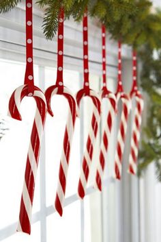 an image of some candy canes hanging on a window sill with the words life hack