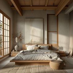 a large bed sitting in a bedroom on top of a wooden floor next to two windows