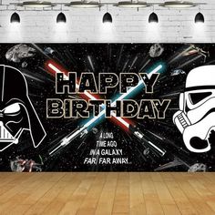 a darth vader and stormtrooper birthday banner on a wooden floor in front of a brick wall