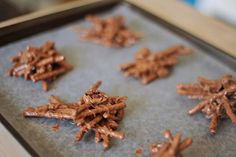 chocolate snowflakes on a baking sheet ready to be baked