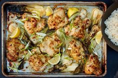 chicken and artichokes on a baking sheet with rice in a bowl next to it