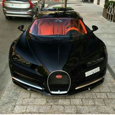 a black bugatti is parked on the street