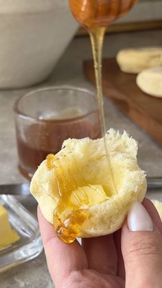 someone is pouring honey onto some bread