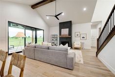 a living room filled with furniture and a fire place in the middle of a room