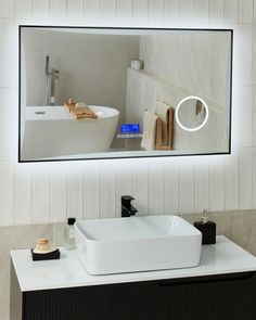 a bathroom sink sitting under a large mirror