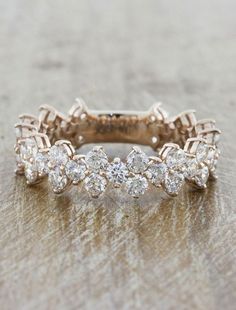 this is an image of a wedding ring with diamonds on the side and in the middle