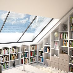 a room filled with lots of books on top of shelves next to a skylight