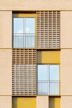 an apartment building with two balconies and windows