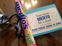 a candy bar wrapped in plastic and tied to a ribbon