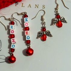 Handmade Christmas Pierced Dangle Earrings, Set Of 2. Ho Ho Alphabet Squares And Red Seed Beads Drop Earrings Angels Are Out Of Pretty Tiny Red Beads And Tiny Silver Tone Wings A Great Addition To Your Wardrobe For The Holidays By Hitting Buy Now You Could Purchase Them Today! Or Bundle Them With Other Items And I Will Send You A Discounted Price And You Save On Shipping! Diy Christmas Earrings Easy, Christmas Jewelry Diy Earrings, Red Jewelry For Christmas Holiday, Red Dangle Jewelry For Christmas, Christmas Earrings To Make, Red Dangle Earrings For Christmas, Handmade Christmas Jewelry, Red Holiday Earrings With Ear Wire, Holiday Red Ear Wire Earrings