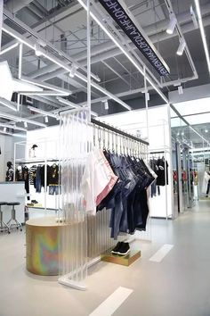 a clothing store with clothes hanging on racks