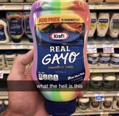 a hand holding up a bottle of real gavo in front of shelves with eggs and yogurt