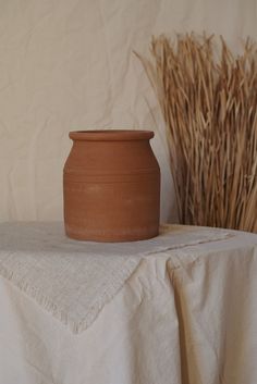 Handcrafted terracotta holder with carved stripes, perfect for organizing kitchen tools or displaying dried flowers, adding a rustic, bohemian touch to home decor. Vase Clay, Terracotta Pottery, Earthy Bohemian, Pots Clay, Terracotta Vase, Rustic Aesthetic, Terracotta Clay, Terracotta Pots, Boho Home